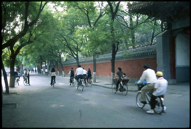 Cycling past the front gate<br><br>Kong Miao--The Confucius Temple :: Beijing, China: The Confucius Temple, Beijing, People's Republic of China
: Bicycles.